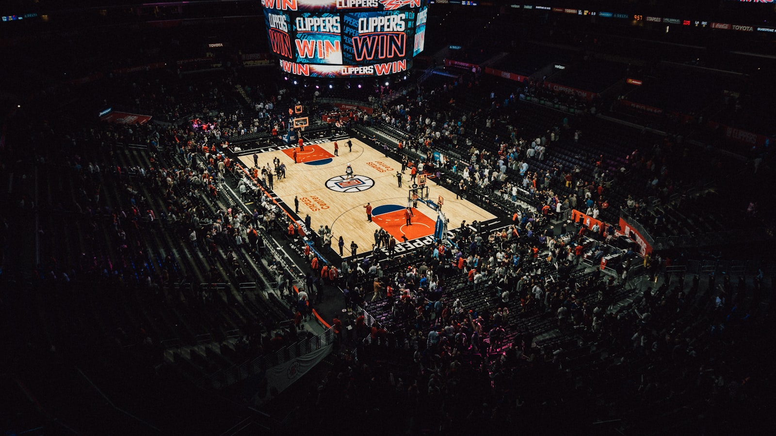AI-generated illustration of an empty NBA arena at night with dramatic lighting over the hardwood court, symbolizing the offseason and championship anticipation