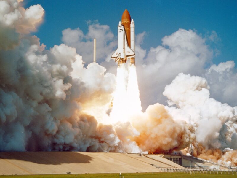 AI-generated illustration of a rocket launching at dusk with stock market chart overlays, symbolizing the SpaceX IPO buzz and its effect on space and chip ETFs