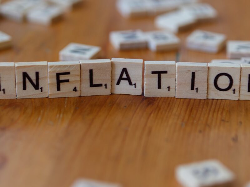 AI-generated editorial illustration of economic gauges showing rising inflation and falling growth, symbolising stagflation risk