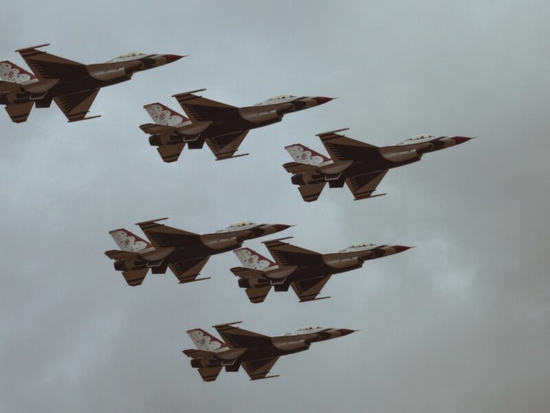 AI-generated illustration of fighter jets launching from a desert Gulf-state airbase at dusk, representing Gulf Arab military involvement in the Iran conflict