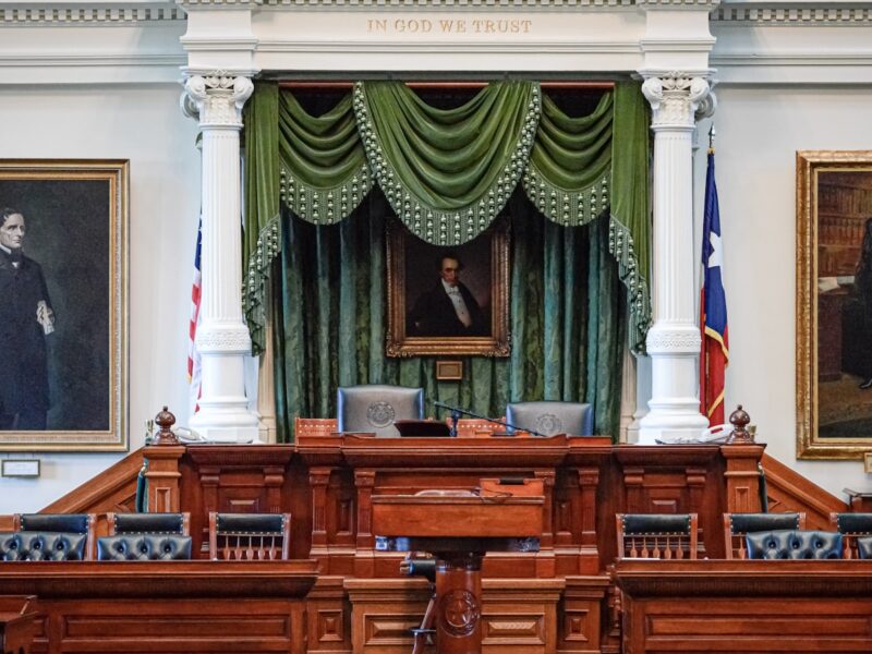 AI-generated illustration of an empty Texas courtroom interior with a judge's bench, wooden gallery seats, and institutional lighting conveying legal solemnity