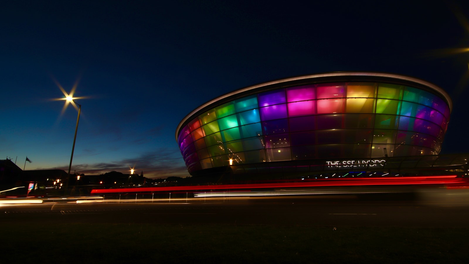 AI-generated illustration of a packed stadium lit with colourful projections during a Commonwealth Games opening ceremony at night