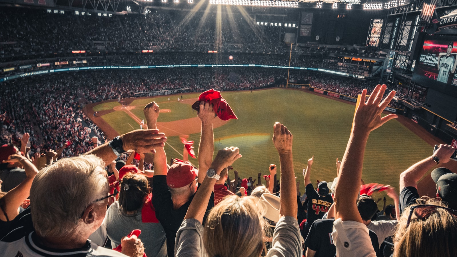 AI-generated illustration of a major league baseball stadium at dusk, pitcher's mound centered, stadium lights glowing warm amber, scoreboard visible in background