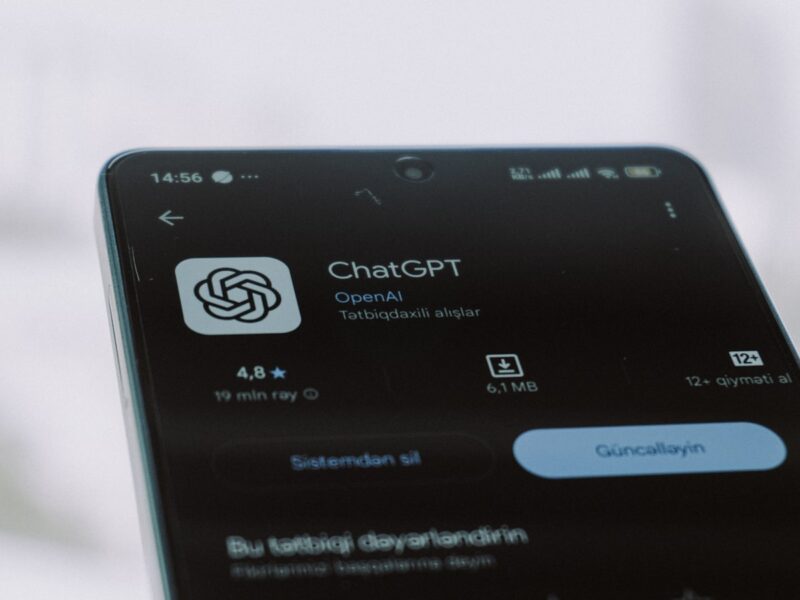 AI-generated illustration of a smartphone showing a health data dashboard beside a stethoscope on a clean white medical desk, representing AI-powered health tools