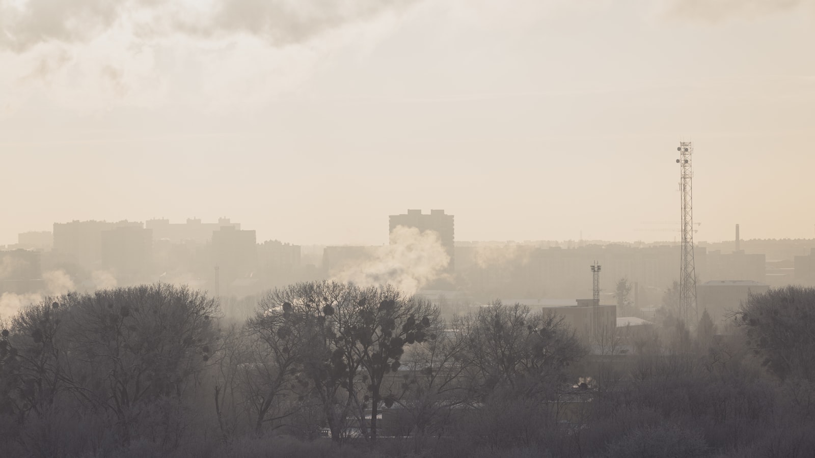 AI-generated illustration of a large warehouse complex burning with thick black smoke columns rising into a grey sky, representing drone strikes on Russian logistics infrastructure